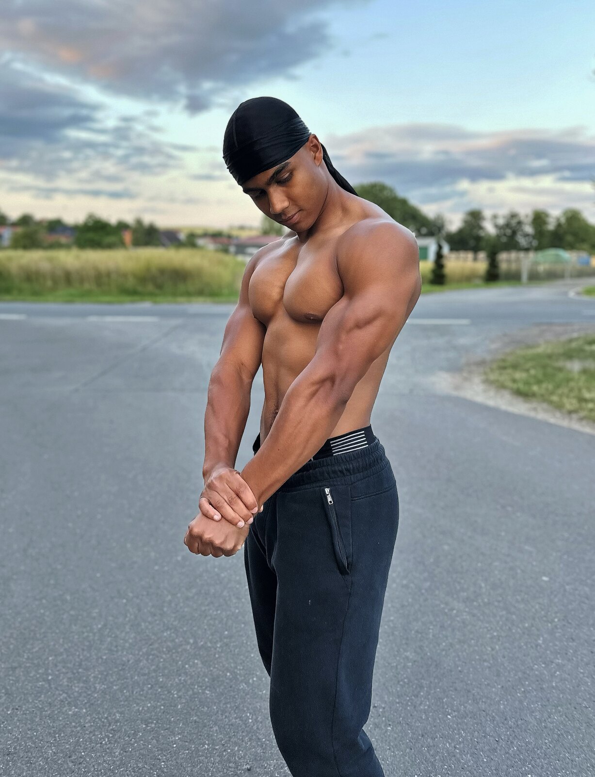 Maximus posing outdoors at sunset, athletic physique