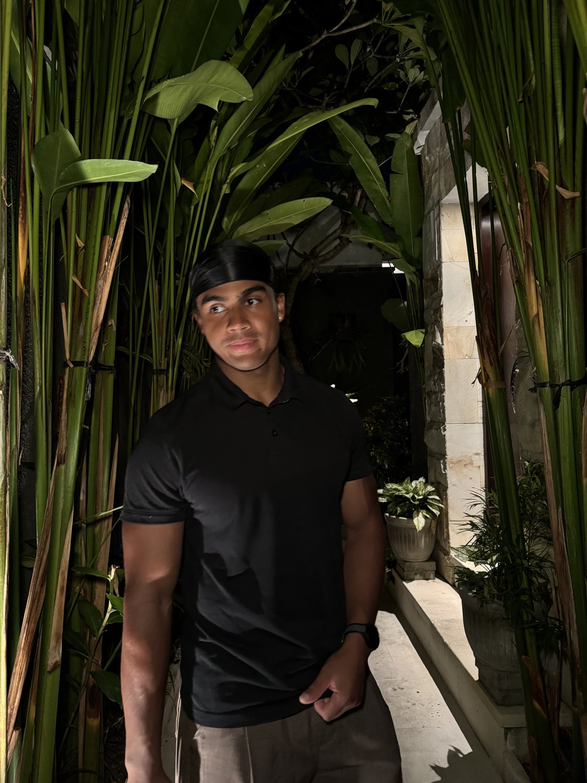 Maximus Glover in a black polo, evening portrait in Bali